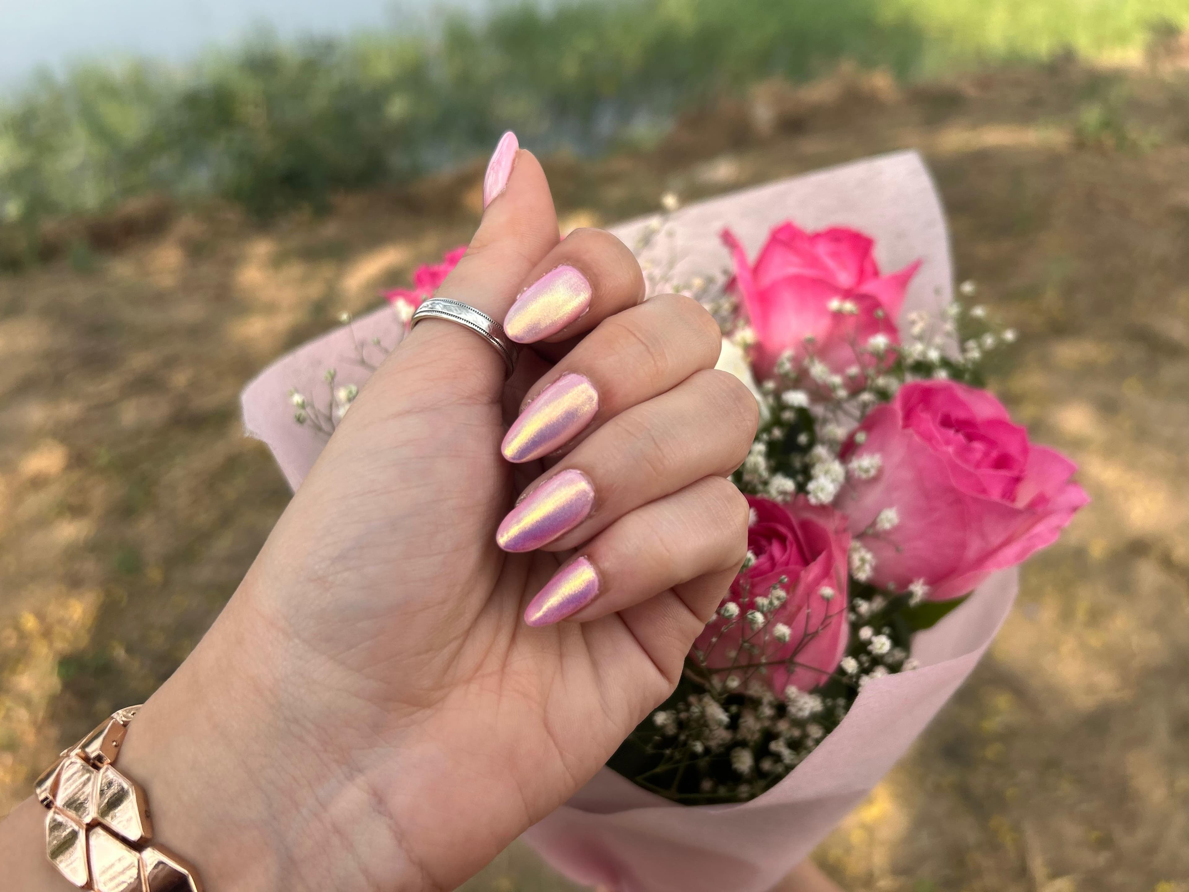 Iridescent pink gel nails with fresh rose styling and a premium glossy finish
