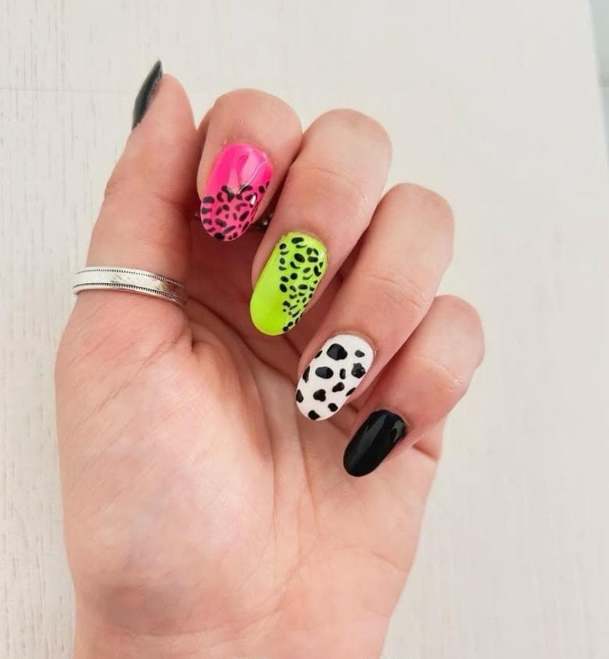 Trendy leopard and cow print nail art with a soft glam gel finish