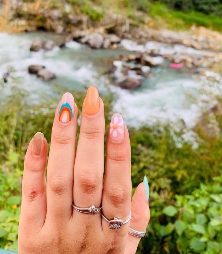 Bright multicolour summer nail art with bold graphic shapes and glossy gel finish